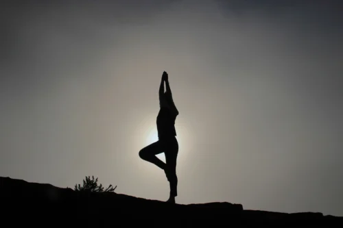 woman doing yoga sloping ground